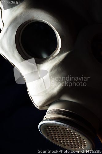 Image of Closeup of a dark gasmask with blurs