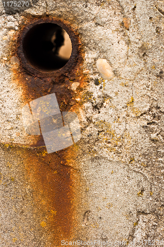 Image of Rusty hole in concrete wall