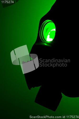 Image of Silhouette of a gas mask in green light