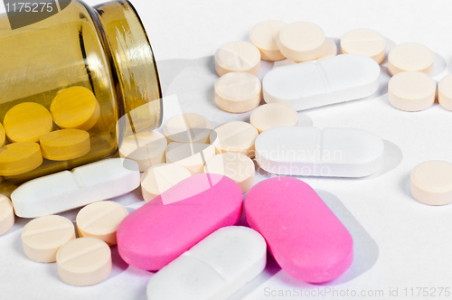 Image of Medicine bottle with pills on white isolated background