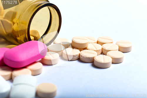 Image of Medicine bottle against white isolated background with pills