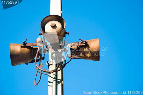 Image of Rusty speakers against blue background