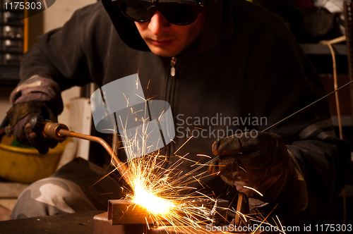 Image of welder at work doing his job