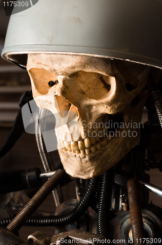 Image of close up of a robot with human skull and helmet