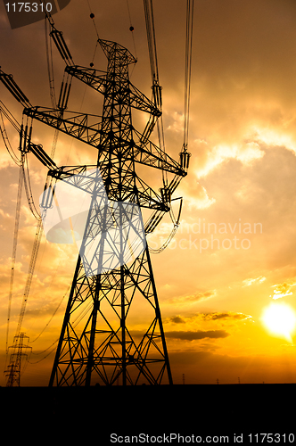 Image of Angle shot of power lines against sunset in the background