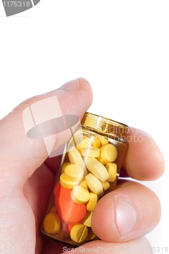 Image of Hand holding medicine bottle full of pills