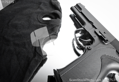 Image of Pistol and mask of a thief over white