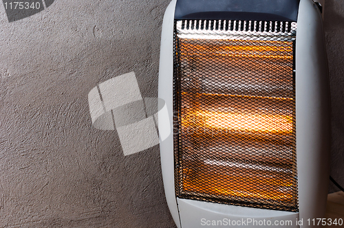 Image of A halogen or electric heater against concrete wall