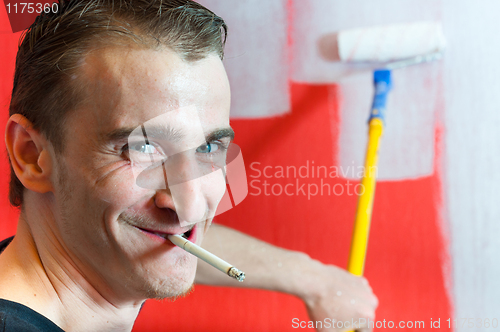 Image of Painter at work with rod in background