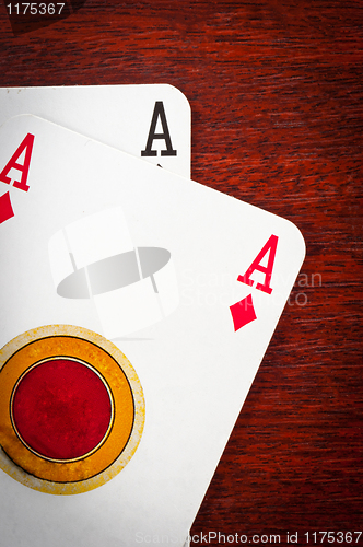 Image of A pair of aces on wooden background