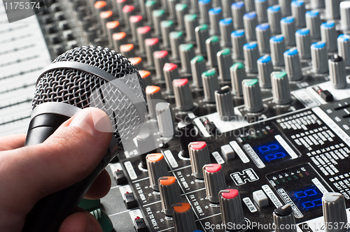 Image of Sound mixer with microphone and hand
