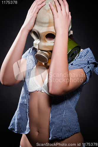 Image of Girl in gasmask holding her head