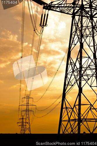 Image of Angle shot of power lines against sunset in the background