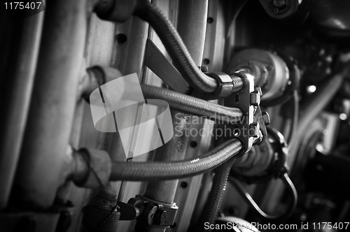 Image of Jet engine part with hoses in black and white