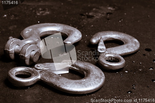 Image of metal cranes on rusty plate