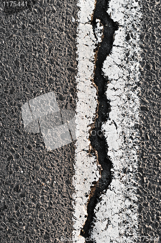 Image of Cracked Asphalt Road Surface With Line