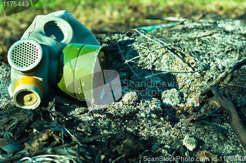 Image of Vintage gasmask on burnt down ground