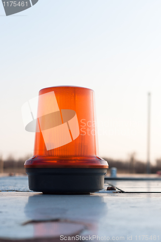 Image of An orange siren on a top of a car