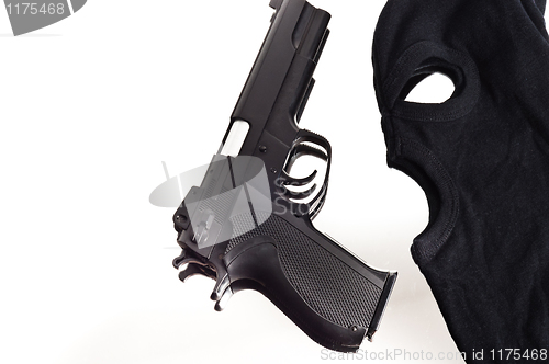 Image of Pistol and mask of a thief over white