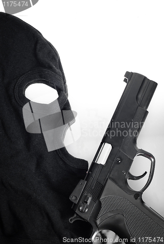 Image of Pistol and mask of a thief over white