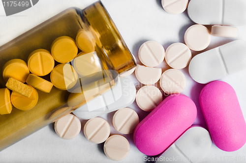 Image of Medicine bottle with pills against white background