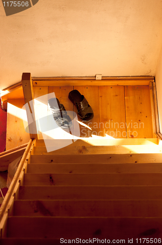 Image of A pair of slippers on stairs in morning light