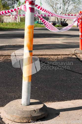 Image of Fresh asphalt isolated from road with barricade