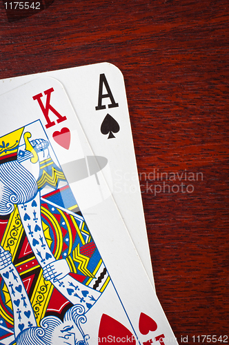 Image of A king and an ace on wooden background