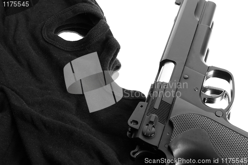 Image of Pistol and mask of a thief over white