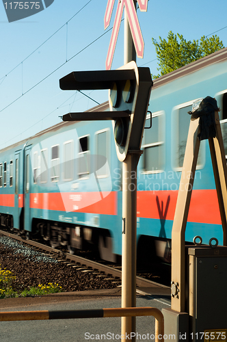 Image of train passing trough station with focus on lamp