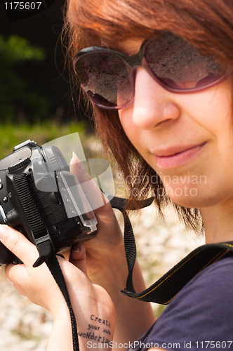 Image of Girl with camera in warm tones