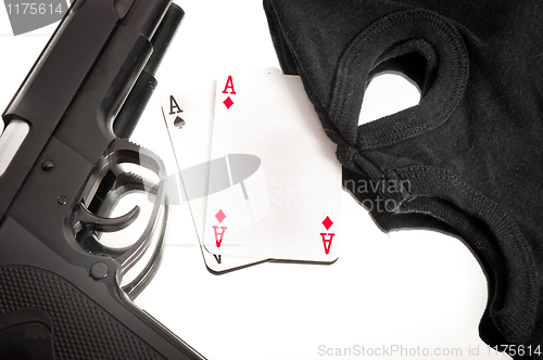 Image of Pistol and mask of a corrup poker player