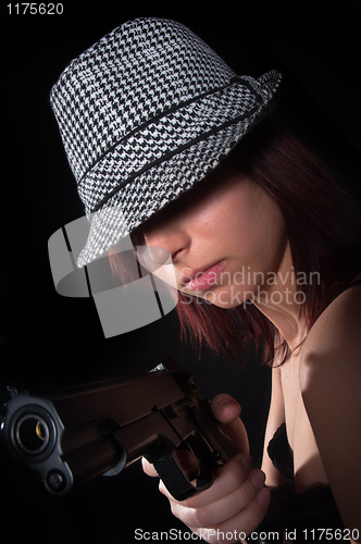 Image of Girl with hat pointing gun