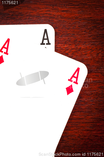 Image of A pair of aces on wooden background