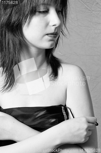 Image of A beautiful young girl undressing in black and white