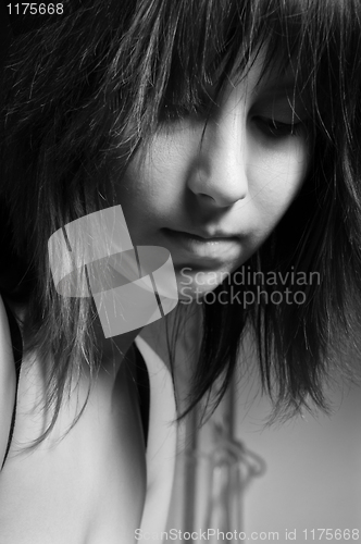 Image of Beautiful young girl looking depressed in black and white