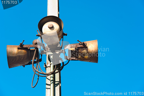 Image of Rusty speakers against blue background