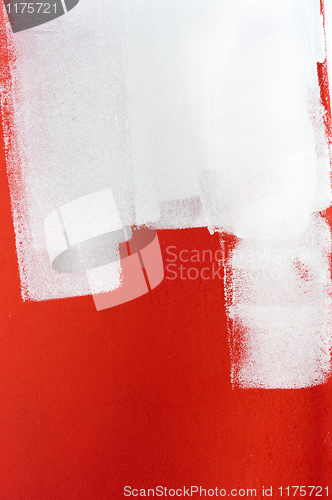 Image of White paint over red wall