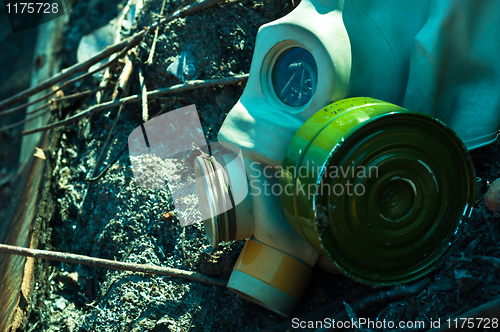 Image of Vintage gasmask on burnt down ground