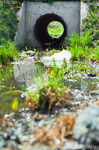 Image of Sewage drainage system with water and grass