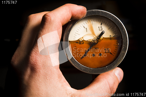 Image of Gas meter in a hands of a man