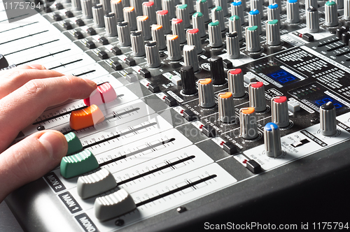 Image of Sound mixer with hand using slider