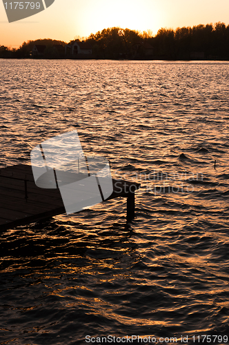 Image of A pier on the shore with sunset