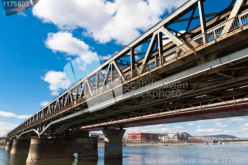 Image of Angle view of a rusty bridge against blue sky