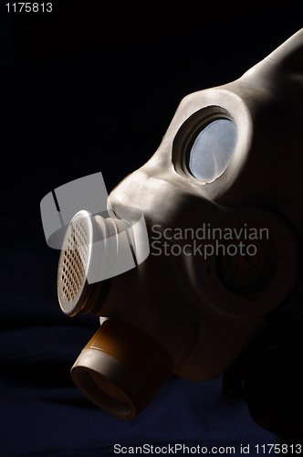 Image of Closeup of a gasmask with blue dark background