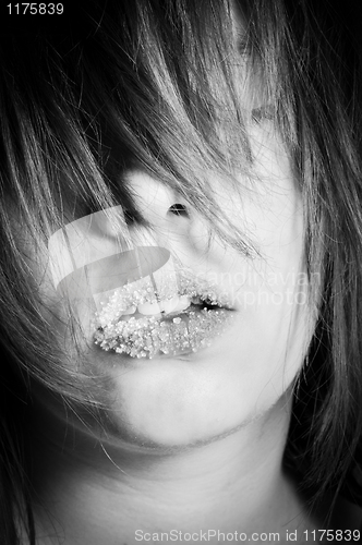 Image of brunette with with little cristal of sugar on her lips