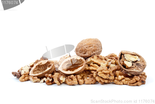 Image of Whole and cracked walnuts with nutshells over kernels