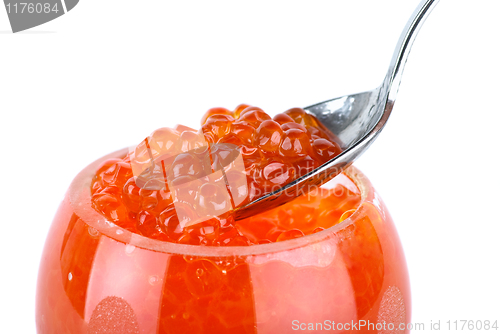 Image of Small metal spoon and glass bowl with red caviar