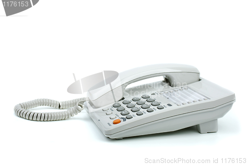 Image of White office phone with handset on-hook