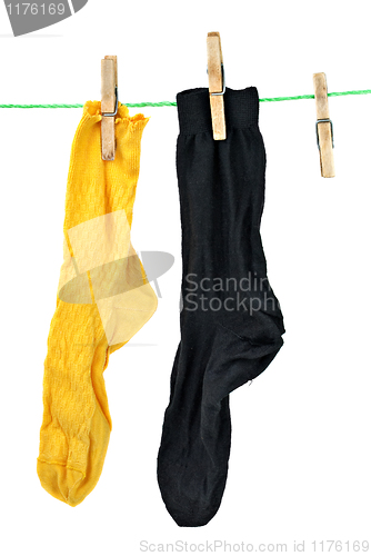 Image of Yellow and black socks hanging on rope